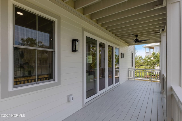 wooden terrace featuring ceiling fan