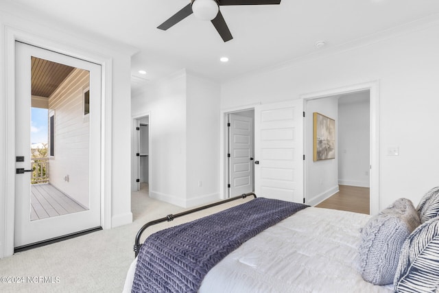 bedroom featuring light carpet, ensuite bathroom, ceiling fan, and crown molding