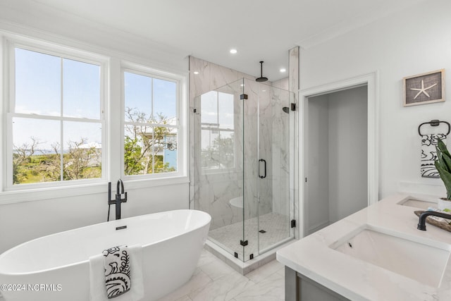 bathroom featuring vanity, ornamental molding, and independent shower and bath