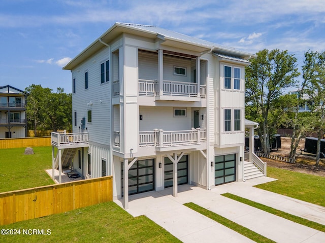 exterior space with a balcony, a garage, and a lawn