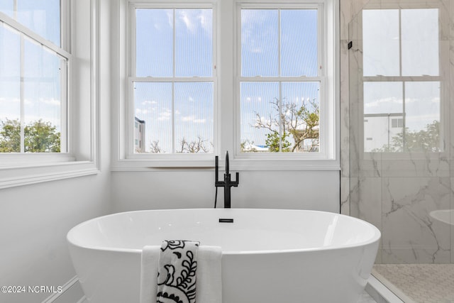 bathroom featuring separate shower and tub