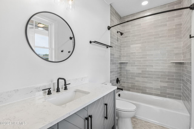 full bathroom featuring toilet, vanity, and tiled shower / bath combo