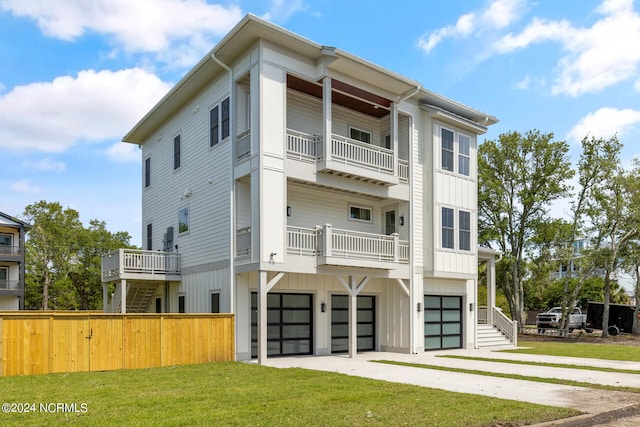 view of front of property with a front yard and a garage