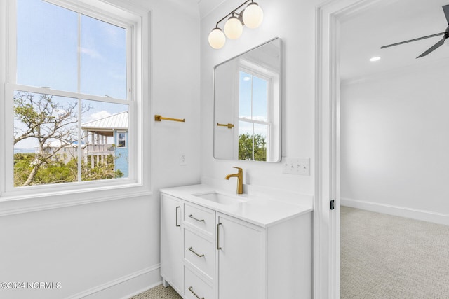 bathroom with ceiling fan, vanity, and a healthy amount of sunlight