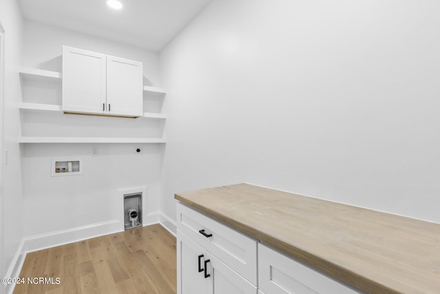 laundry area featuring cabinets, hookup for an electric dryer, gas dryer hookup, hookup for a washing machine, and light hardwood / wood-style floors