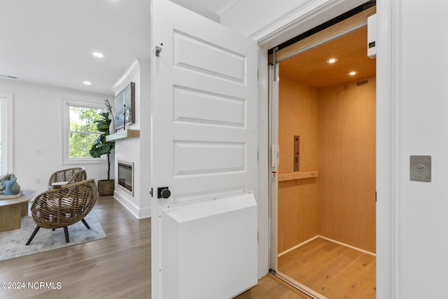 interior space with elevator and hardwood / wood-style floors