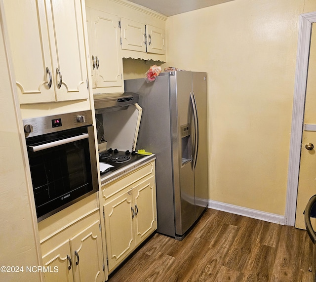 kitchen with white cabinetry, dark hardwood / wood-style flooring, extractor fan, and stainless steel appliances