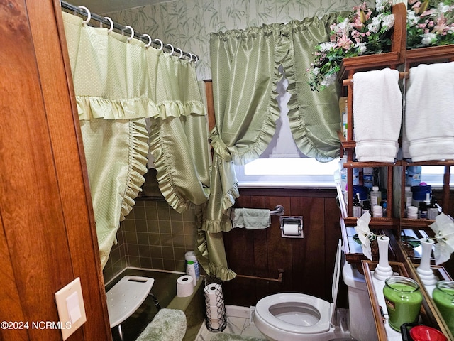 bathroom featuring tile floors, a healthy amount of sunlight, and toilet