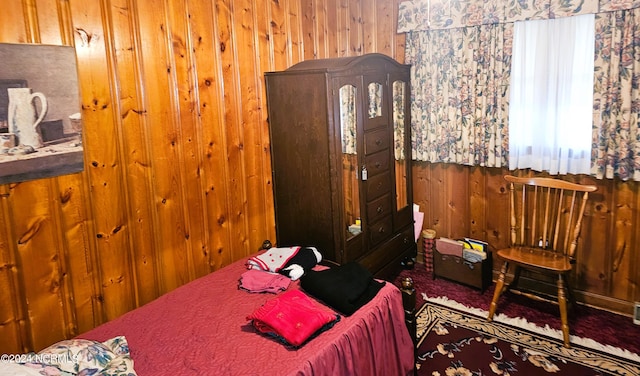 bedroom featuring wooden walls