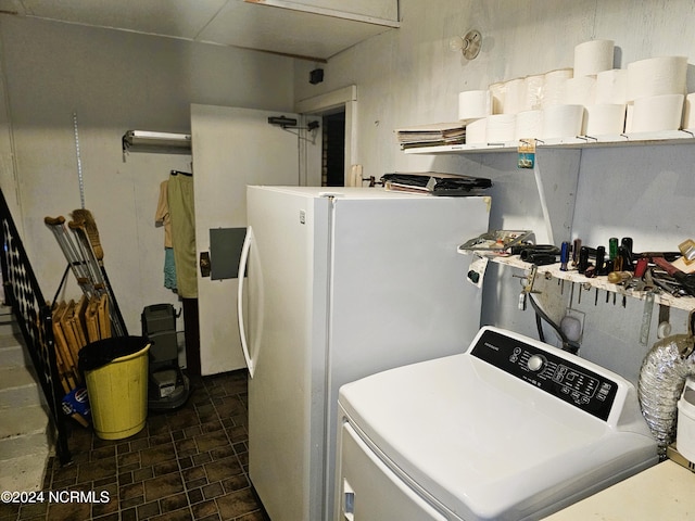 washroom featuring washer / clothes dryer and dark tile floors