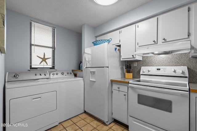 kitchen featuring washing machine and clothes dryer, light tile floors, white cabinetry, white appliances, and a textured ceiling