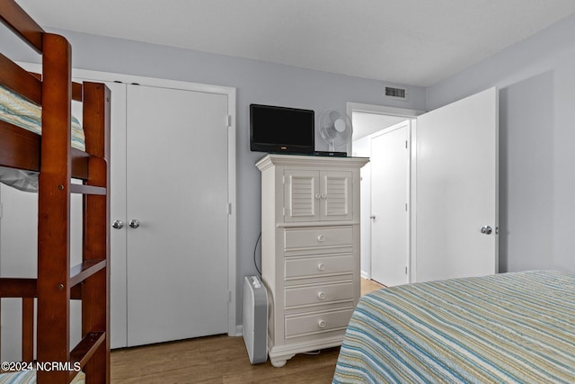 bedroom with hardwood / wood-style flooring