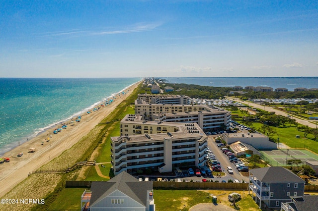 birds eye view of property featuring a beach view and a water view