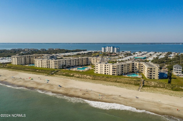 drone / aerial view with a beach view and a water view