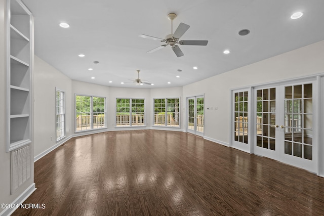 unfurnished living room with french doors, dark hardwood / wood-style floors, and ceiling fan