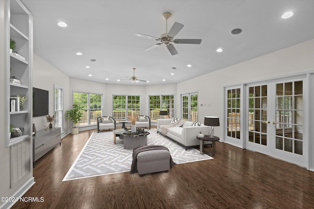 living room with ceiling fan, dark hardwood / wood-style floors, a wealth of natural light, and french doors