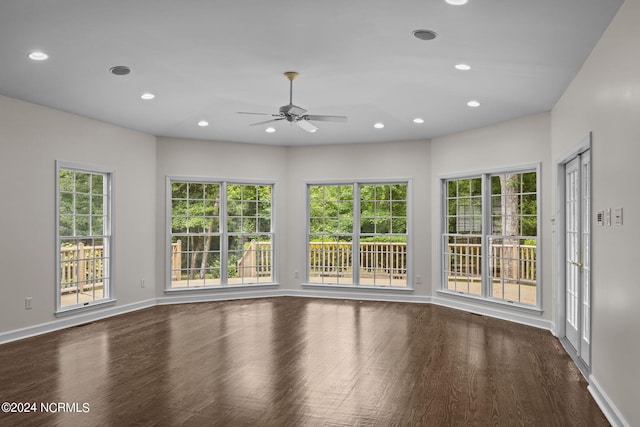 spare room featuring wood-type flooring, ceiling fan, and a healthy amount of sunlight