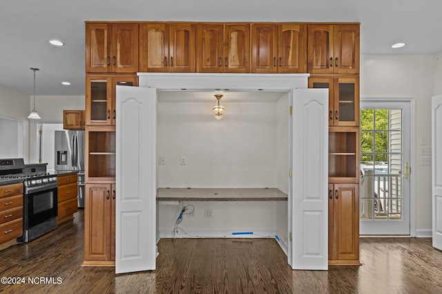 kitchen featuring dark hardwood / wood-style floors, stainless steel appliances, and hanging light fixtures