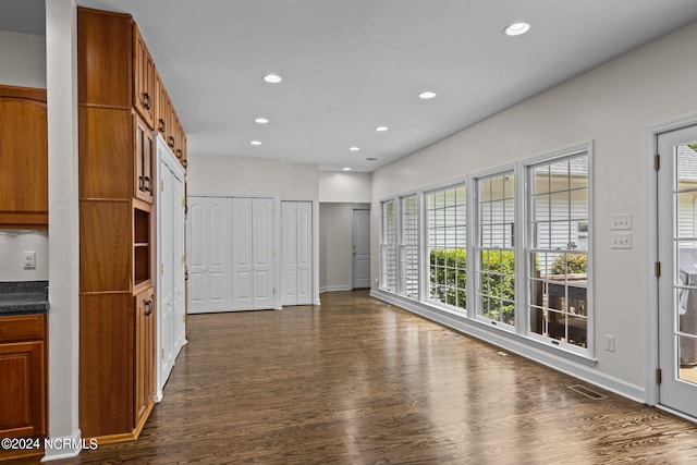 unfurnished room with dark wood-type flooring