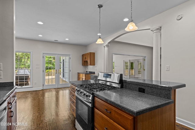 kitchen with french doors, hanging light fixtures, dark hardwood / wood-style floors, decorative columns, and appliances with stainless steel finishes