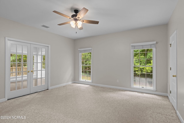 carpeted empty room featuring ceiling fan and french doors