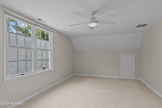 bonus room featuring ceiling fan, light colored carpet, and vaulted ceiling