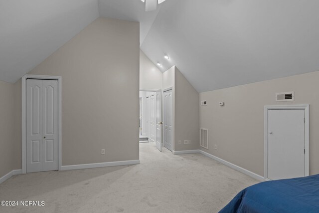 carpeted bedroom featuring vaulted ceiling