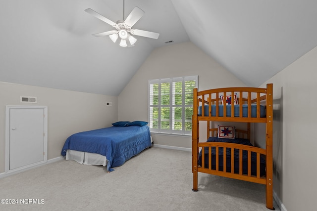 carpeted bedroom with ceiling fan and vaulted ceiling