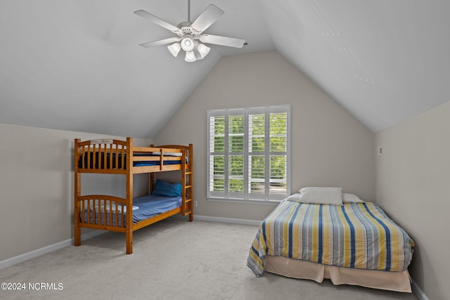 bedroom with ceiling fan, lofted ceiling, and light carpet