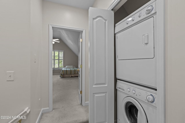 laundry area featuring light carpet, ceiling fan, and stacked washer and clothes dryer