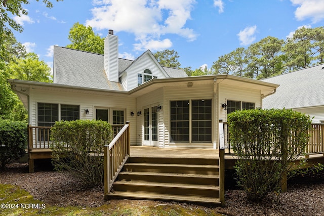 back of house with a deck