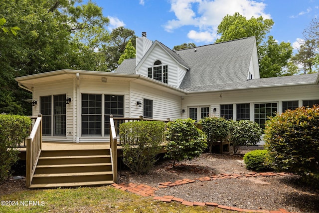 rear view of house with a wooden deck