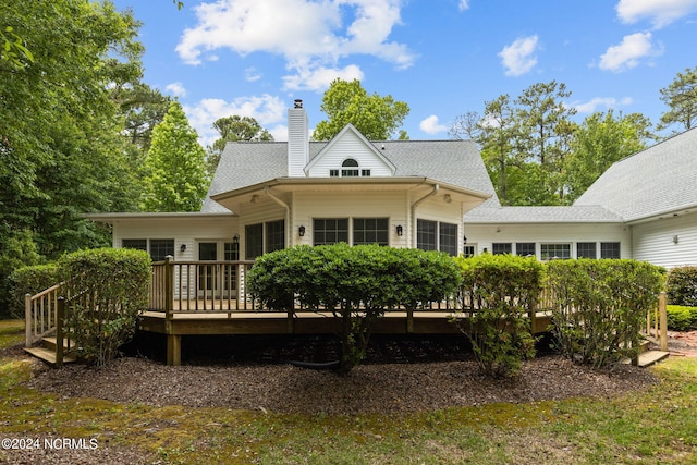 rear view of property featuring a deck