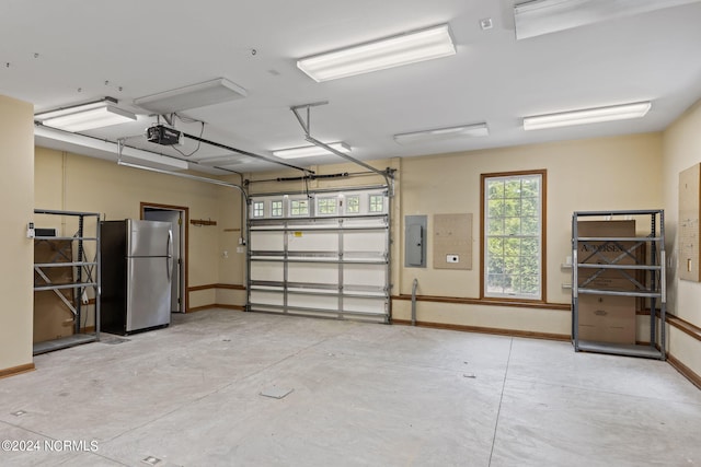 garage with stainless steel fridge, electric panel, and a garage door opener