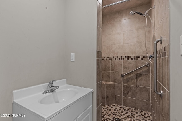 bathroom with vanity and tiled shower