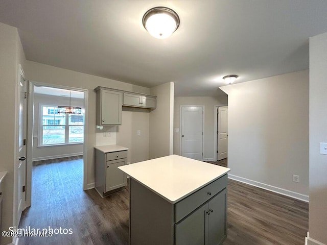 kitchen with a center island, gray cabinets, and dark hardwood / wood-style flooring