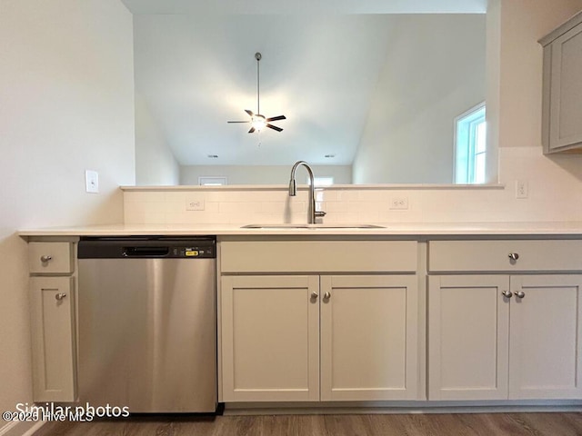 kitchen featuring ceiling fan, stainless steel dishwasher, wood-type flooring, and sink