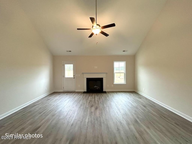 unfurnished living room featuring ceiling fan and dark hardwood / wood-style floors