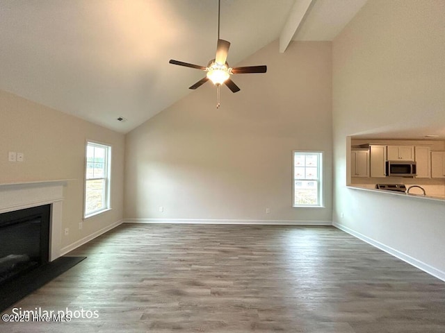 unfurnished living room featuring ceiling fan, high vaulted ceiling, and hardwood / wood-style flooring