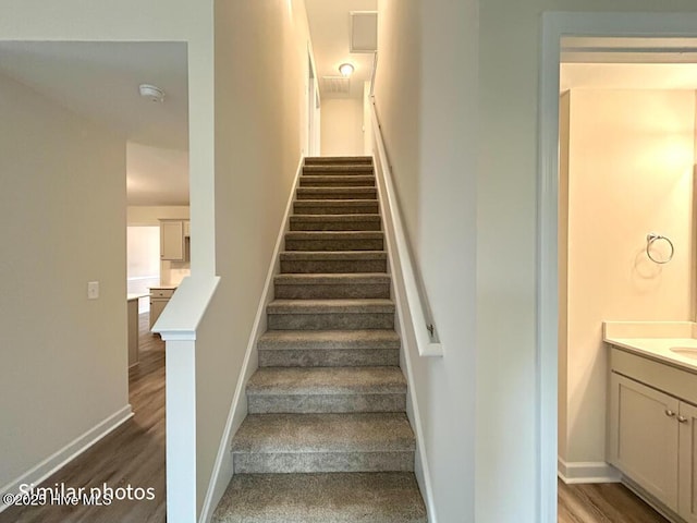 stairway with wood-type flooring