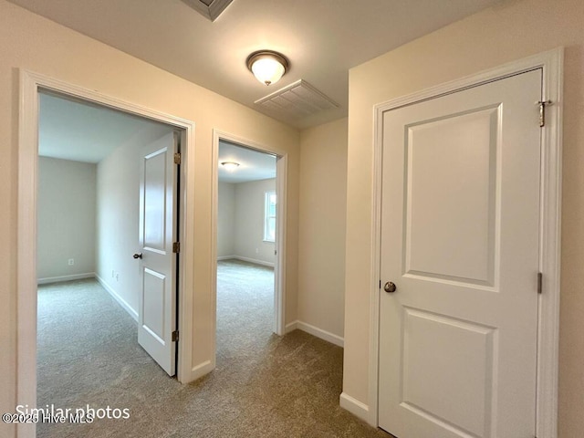 corridor featuring light carpet