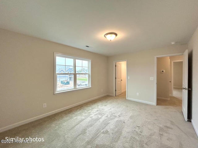 unfurnished bedroom featuring light carpet