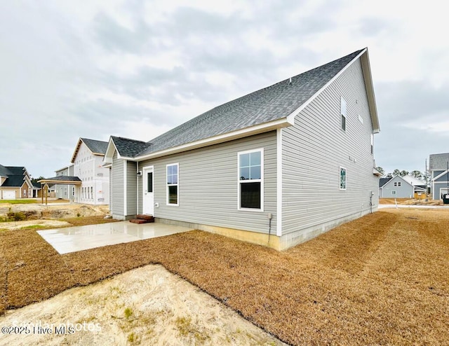 rear view of property with a patio area and a yard