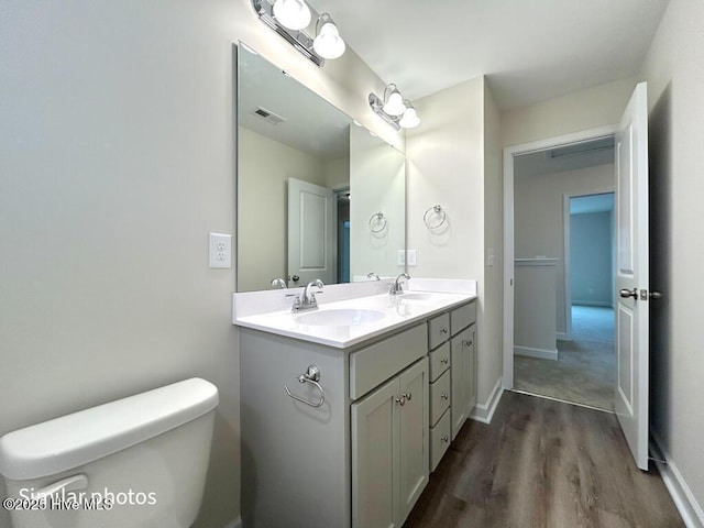 bathroom featuring hardwood / wood-style floors, toilet, and vanity