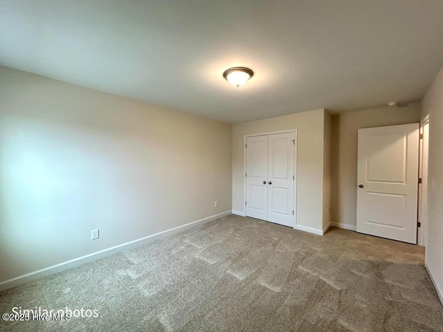 unfurnished bedroom with a closet and carpet flooring