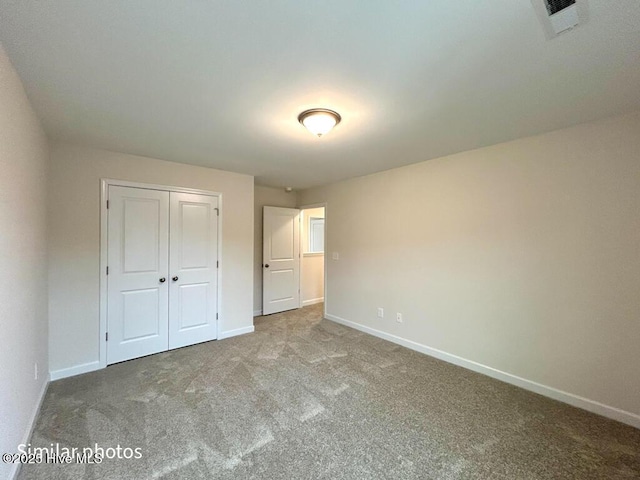 unfurnished bedroom with carpet and a closet