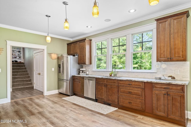 kitchen with a healthy amount of sunlight, stainless steel appliances, and light hardwood / wood-style floors