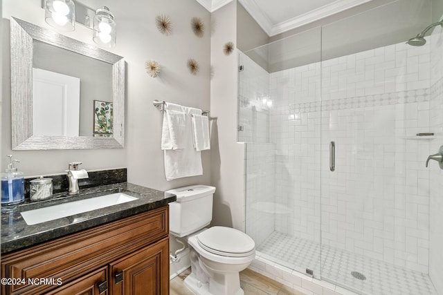 bathroom featuring walk in shower, crown molding, vanity, and toilet