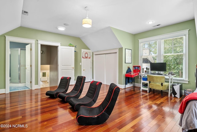 interior space featuring hardwood / wood-style floors and lofted ceiling