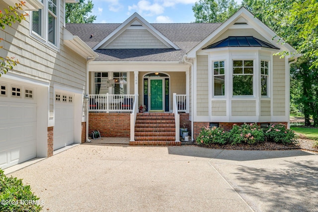 view of front of property with a porch and a garage